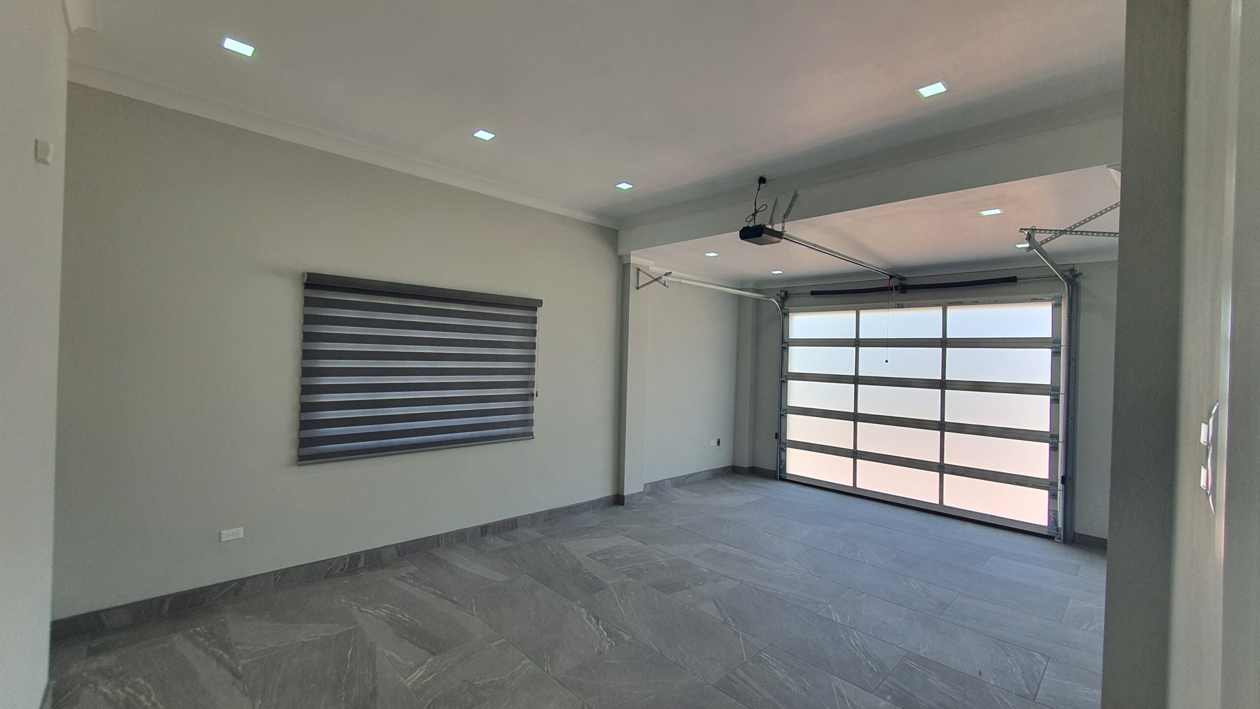 Modern two-car garage with remote-controlled rolling door in a Freeport home at Lima Estates.