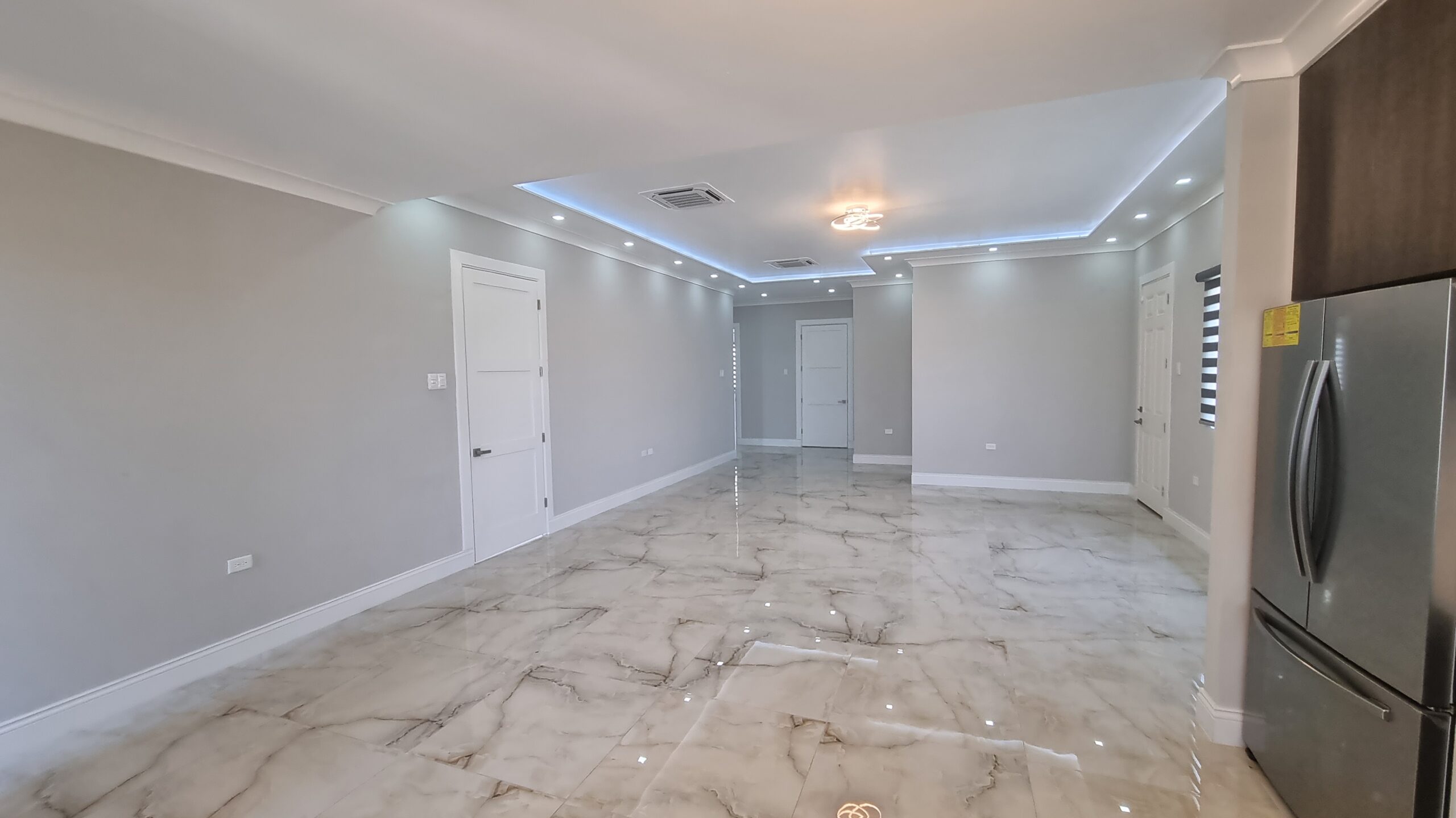 Modern open floor plan with kitchen, living room, and dining room in a Freeport home.