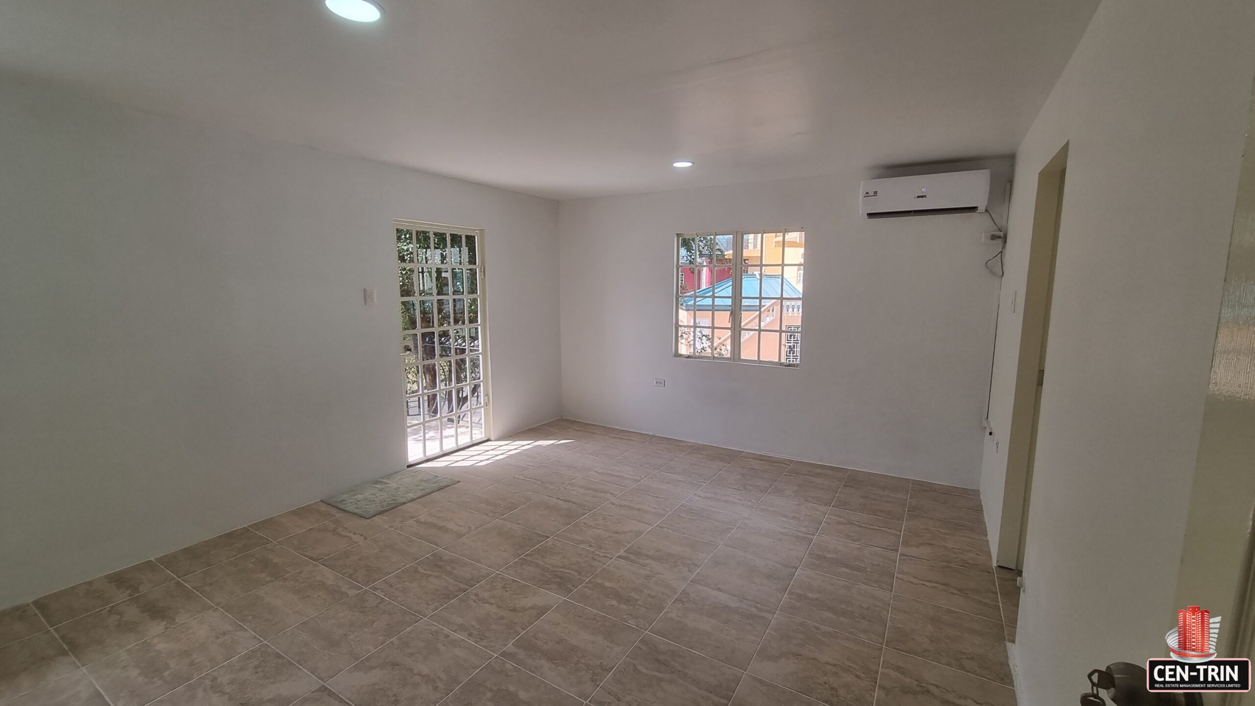 Master bedroom with outdoor balcony & window in a 3 bedroom townhouse rental.