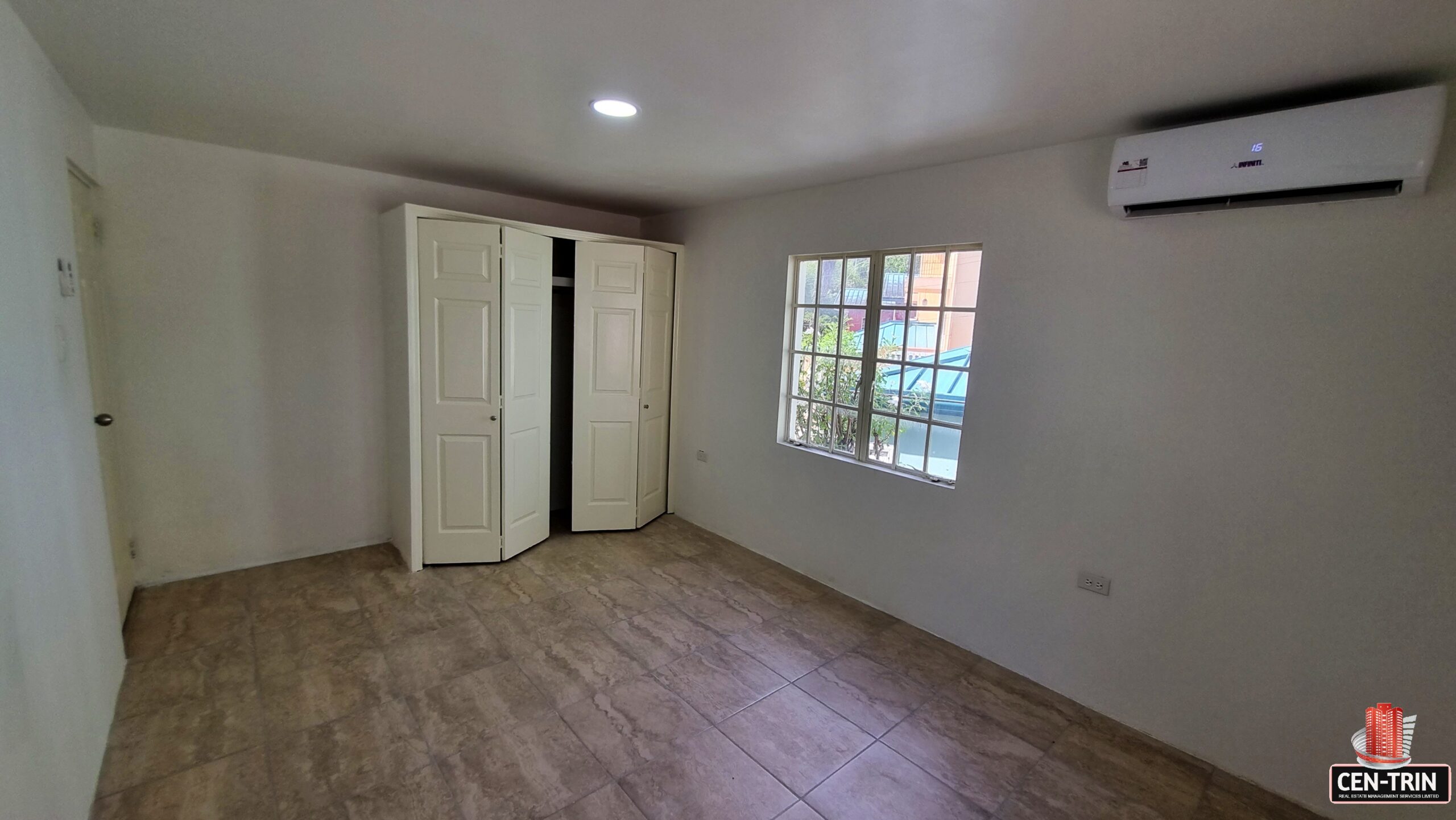 Bedroom with closet, window, and twin bed space in a 3 bedroom townhouse rental.