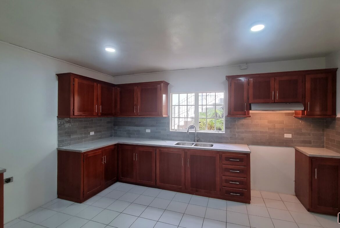 Modern kitchen with stainless steel appliances and granite countertops in a 3 bedroom townhouse rental.