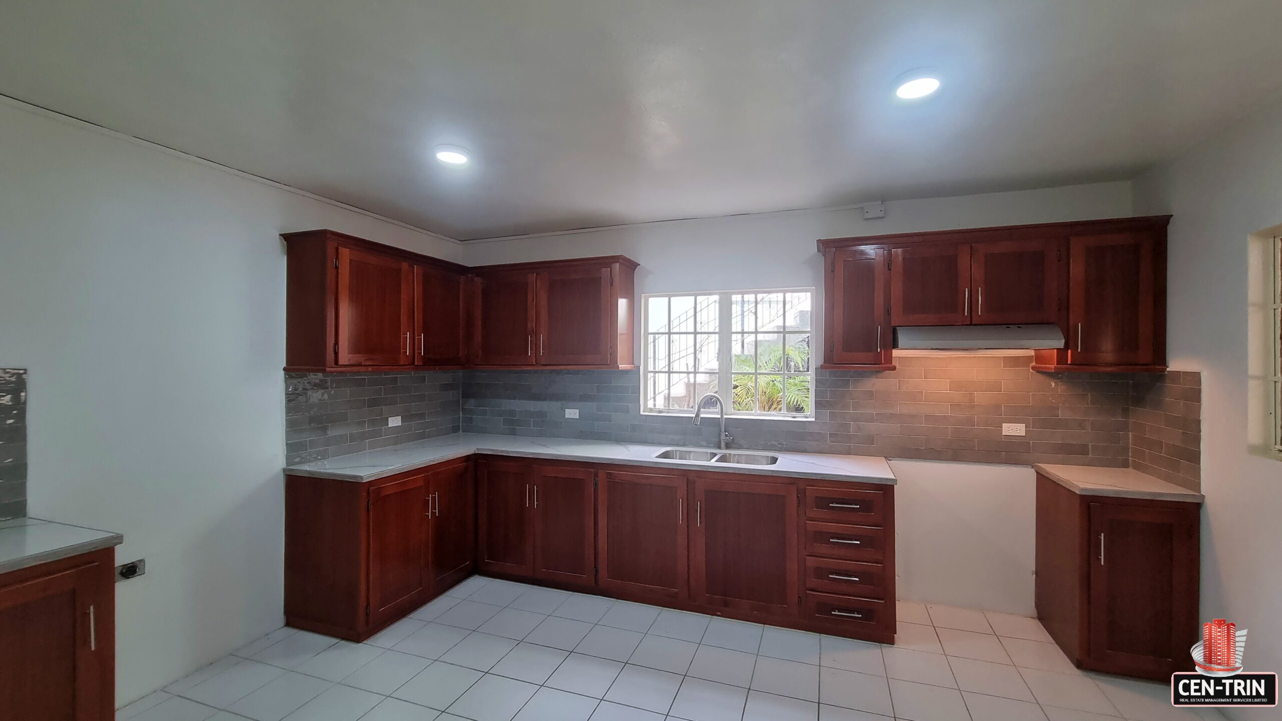 Modern kitchen with stainless steel appliances and granite countertops in a 3 bedroom townhouse rental.