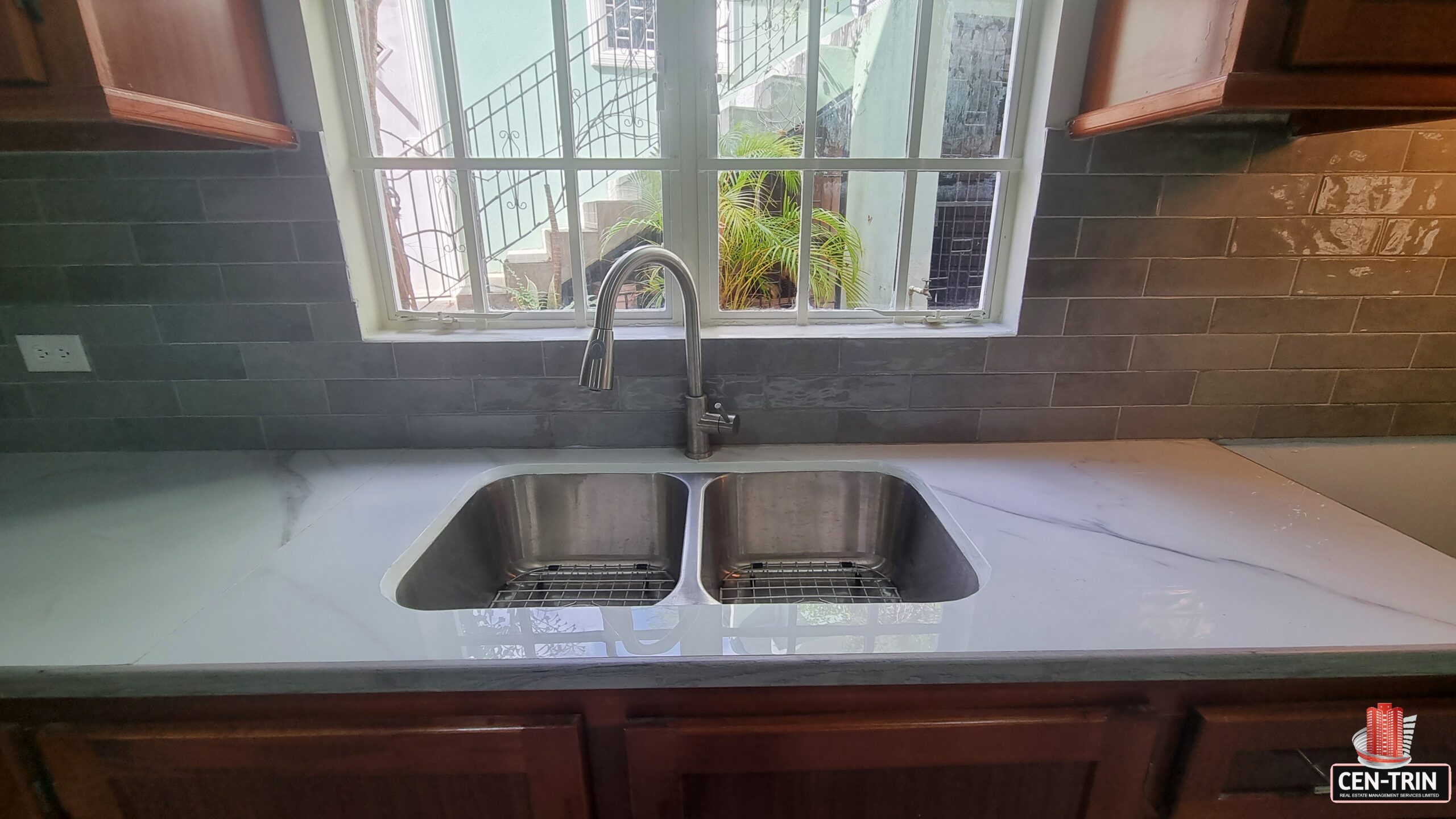Double sink and window in kitchen of a 3 bedroom townhouse rental.
