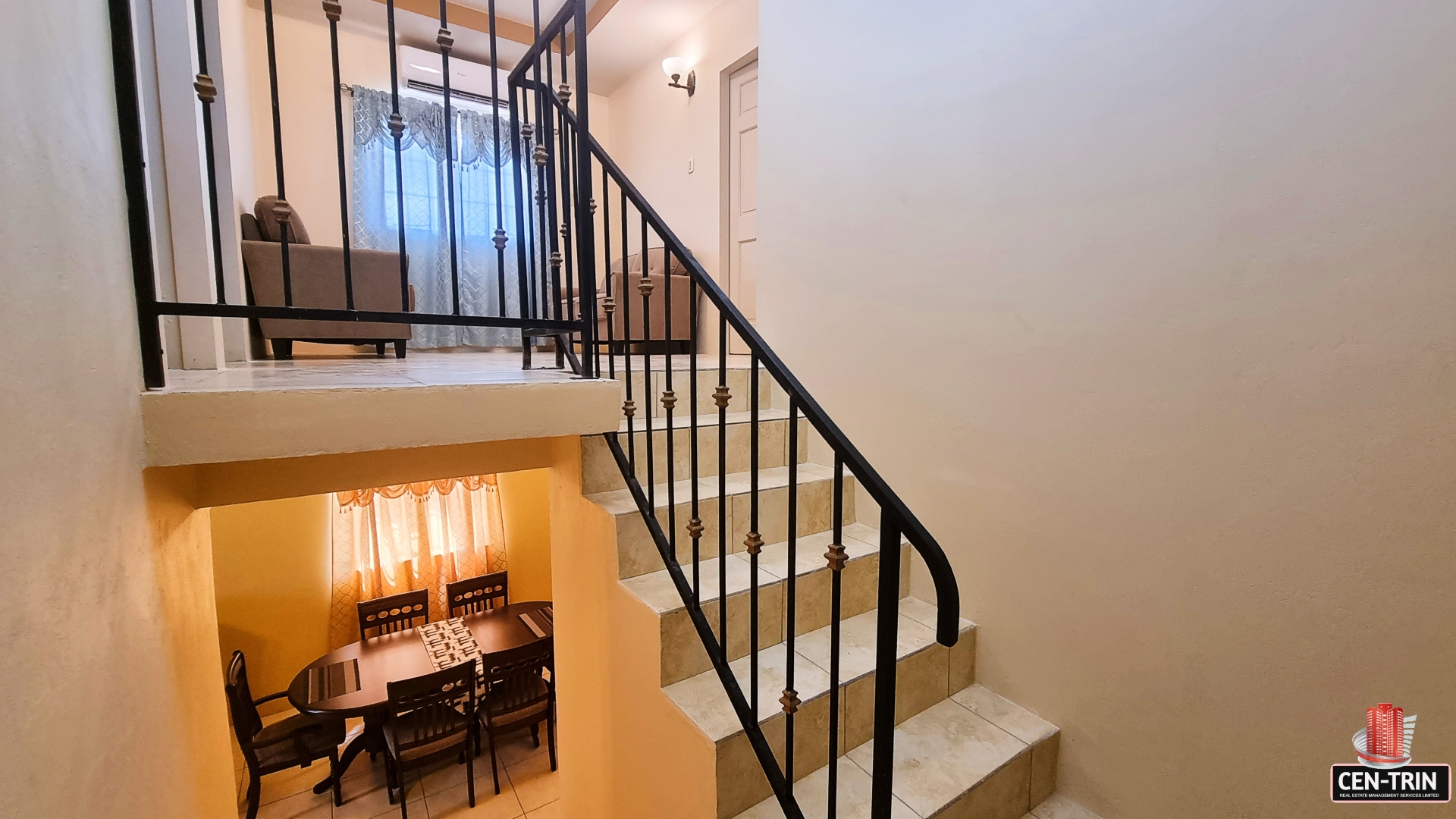 Staircase landing with two doors and a window in a townhouse for sale.