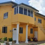 Image of a multi-unit apartment building, representing a rental property for sale and an investment opportunity in D'Abadie