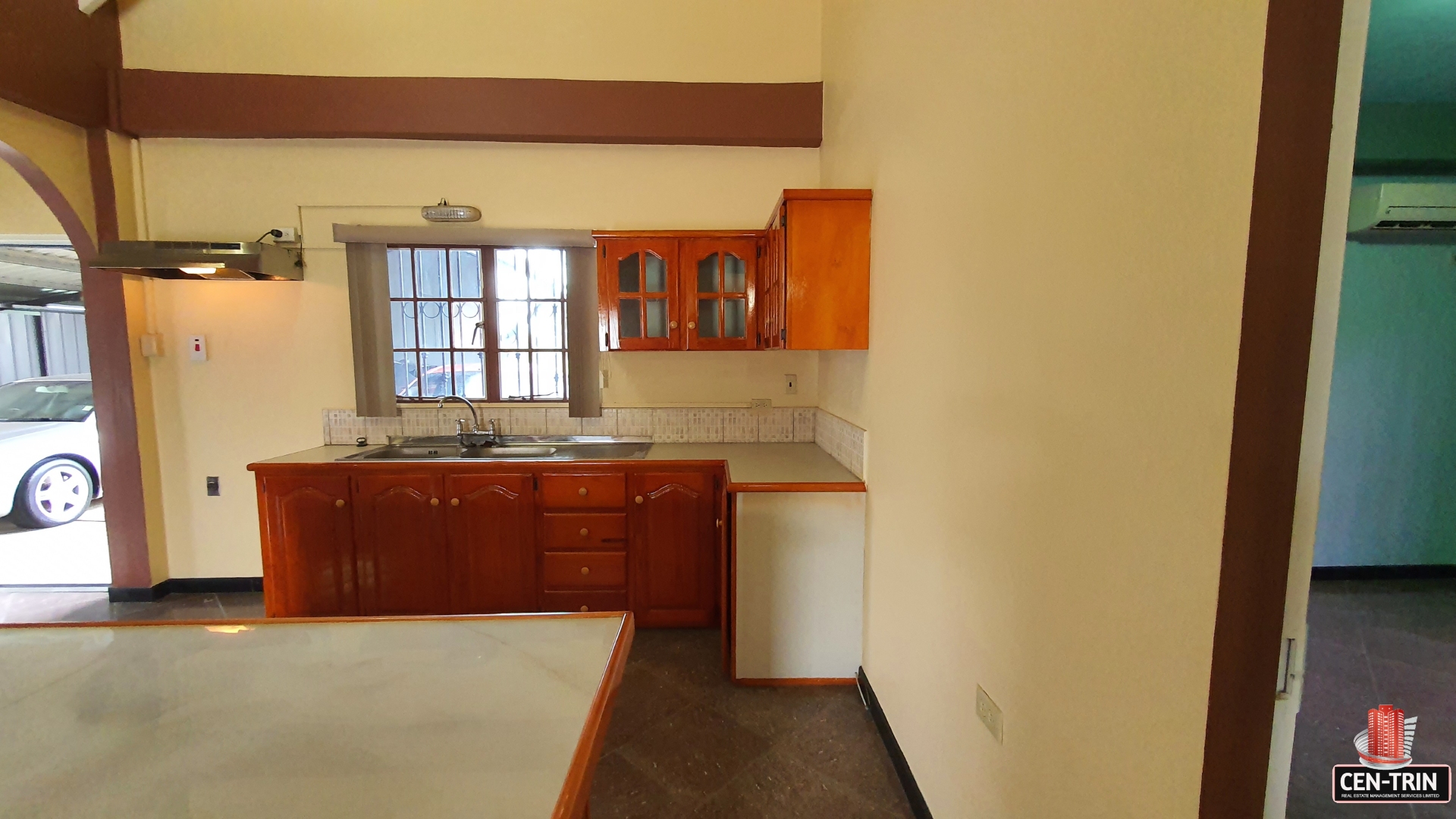 A charming kitchen with wooden cabinets and a sink with a faucet.