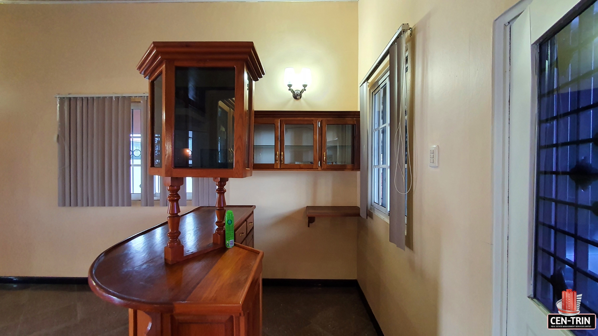A charming kitchen with a breakfast bar, cabinets and a window