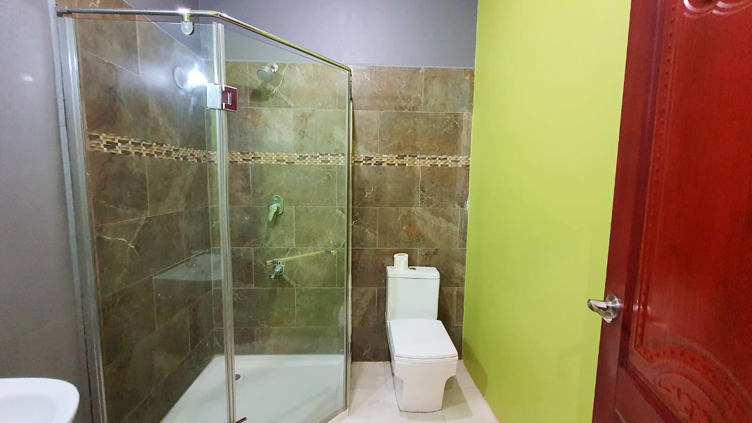 Spacious living area with comfortable furniture in Chaguanas gated apartment (Cen-Trin Real Estate)