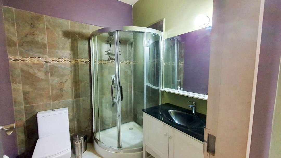 Spacious living area with comfortable furniture in Chaguanas gated apartment (Cen-Trin Real Estate)