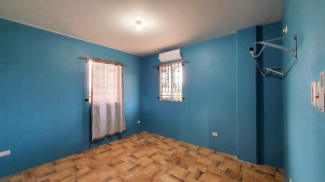 Spacious living area with comfortable furniture in Chaguanas gated apartment (Cen-Trin Real Estate)