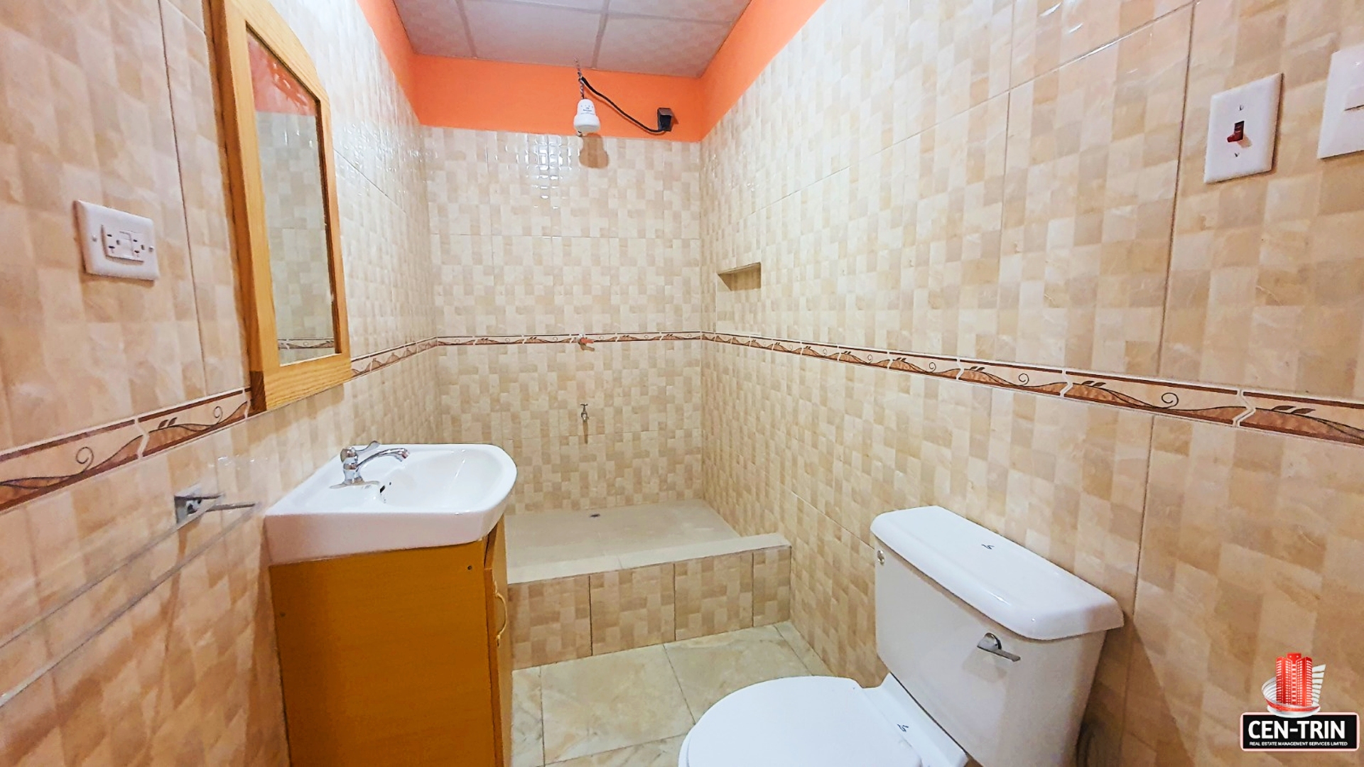 Bathroom interior with a toilet, sink with faucet, and a shower enclosure with a glass door.