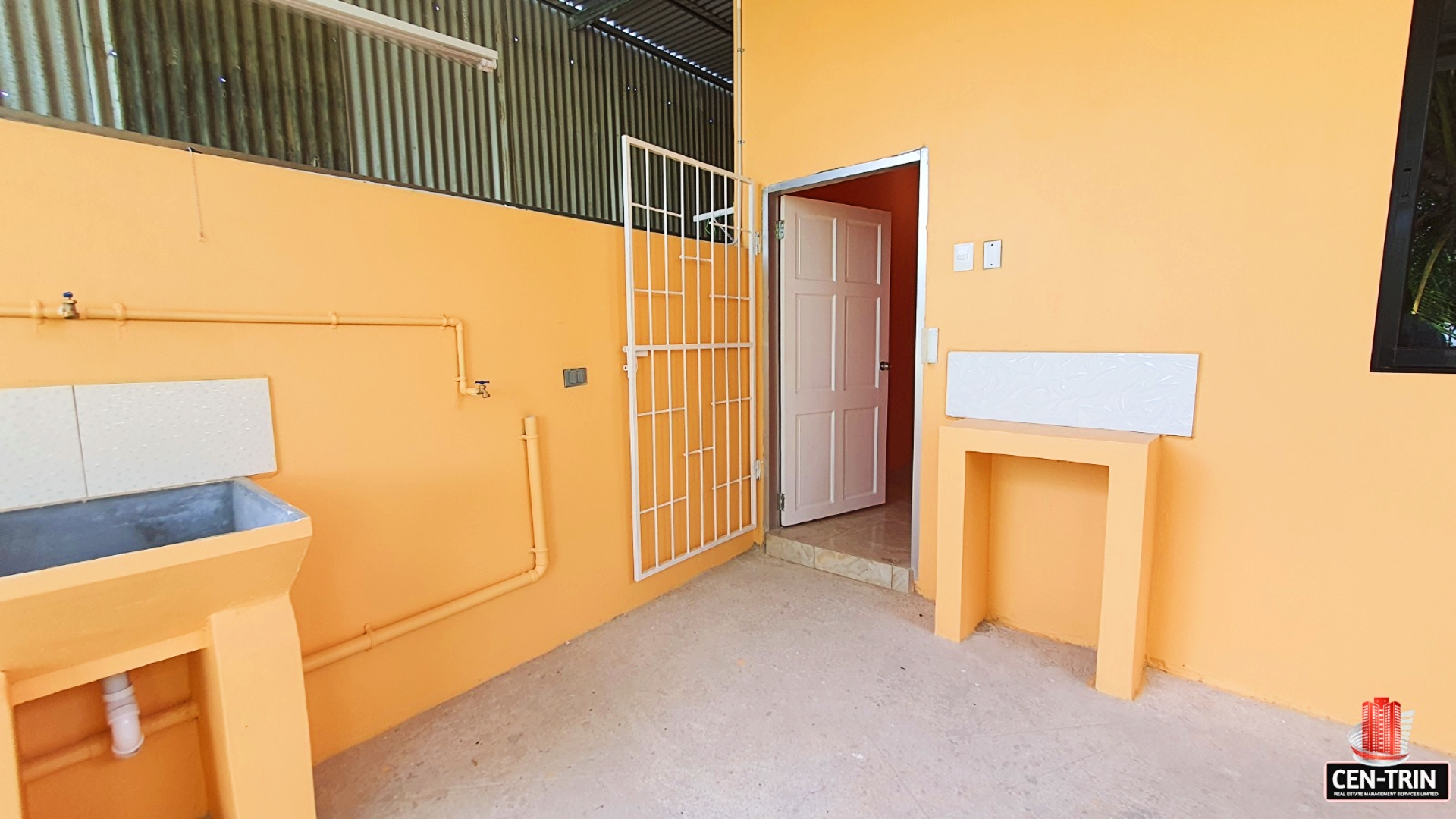 A sink on the outdoor area of the apartment for laundry