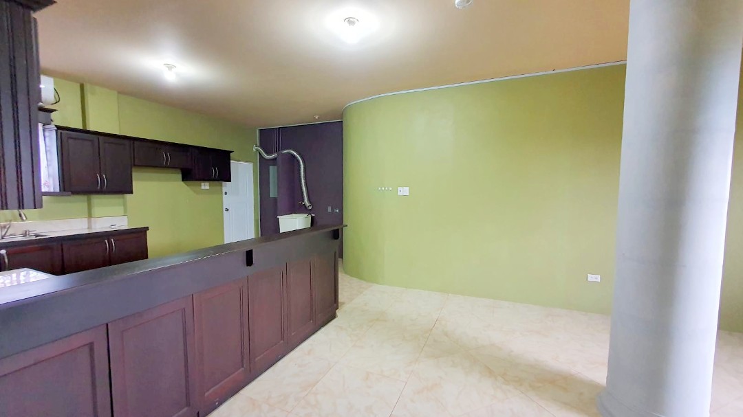 Spacious living area with comfortable furniture in Chaguanas gated apartment (Cen-Trin Real Estate)