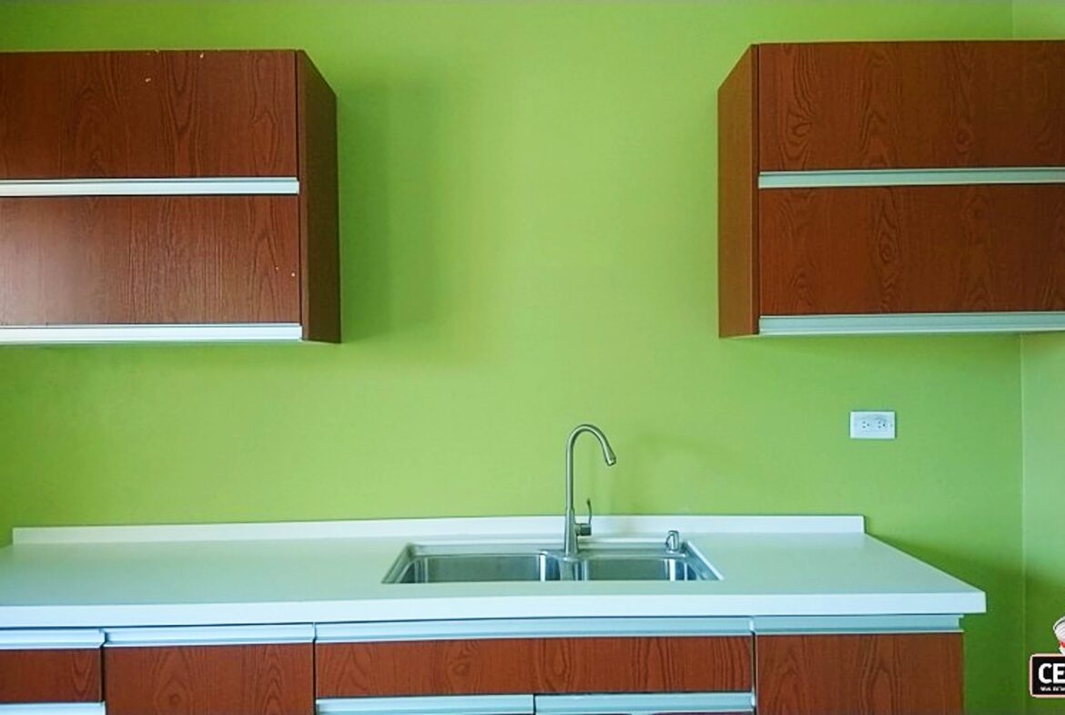 Spacious & Secure Apartment for Rent in Cunupia - 2 Bedroom in a secure, gated community on Chin Chin Road, Cunupia | A bright kitchen with green walls and white countertops in a two-bedroom apartment