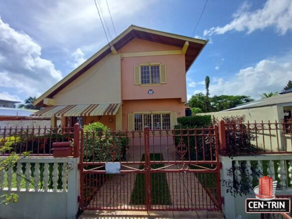 The front of a 3-Bedroom House for Sale with a red gate