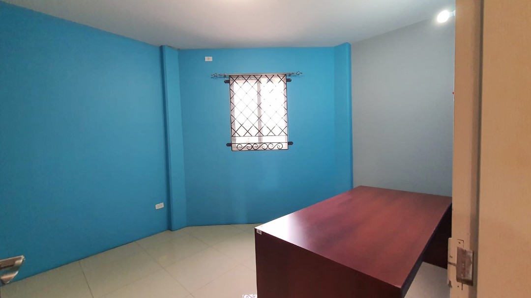 Spacious living area with comfortable furniture in Chaguanas gated apartment (Cen-Trin Real Estate)