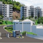 Car parked in front of modern apartment building on a hill