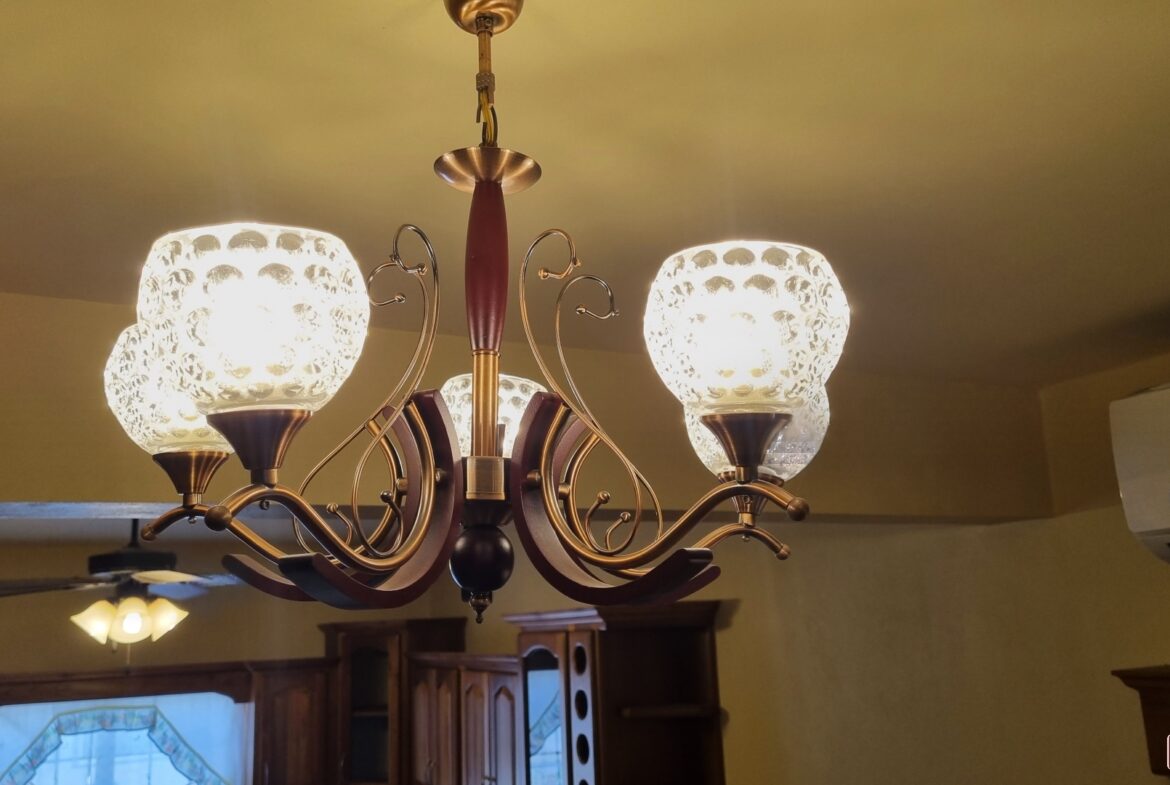 Living room in townhouse for sale with a modern crystal chandelier.
