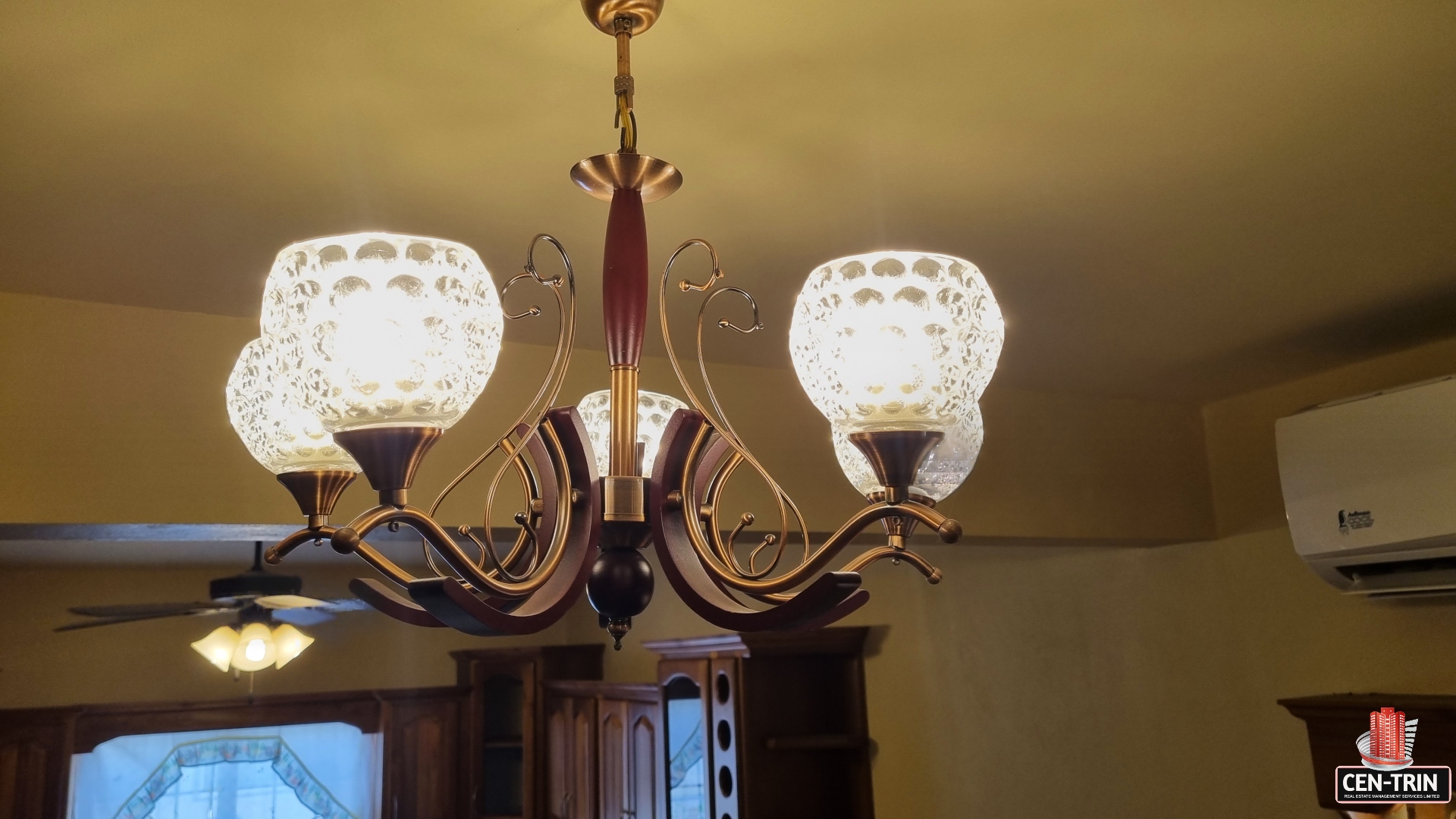 Living room in townhouse for sale with a modern crystal chandelier.