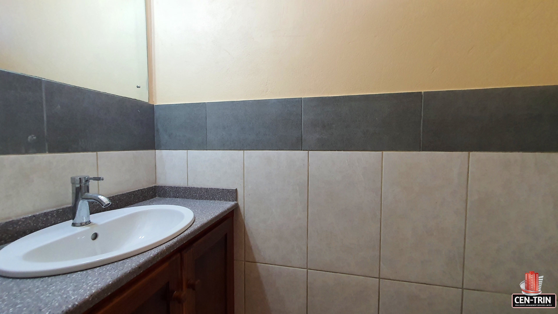 Bathroom sink with faucet and mirror in townhouse for sale.