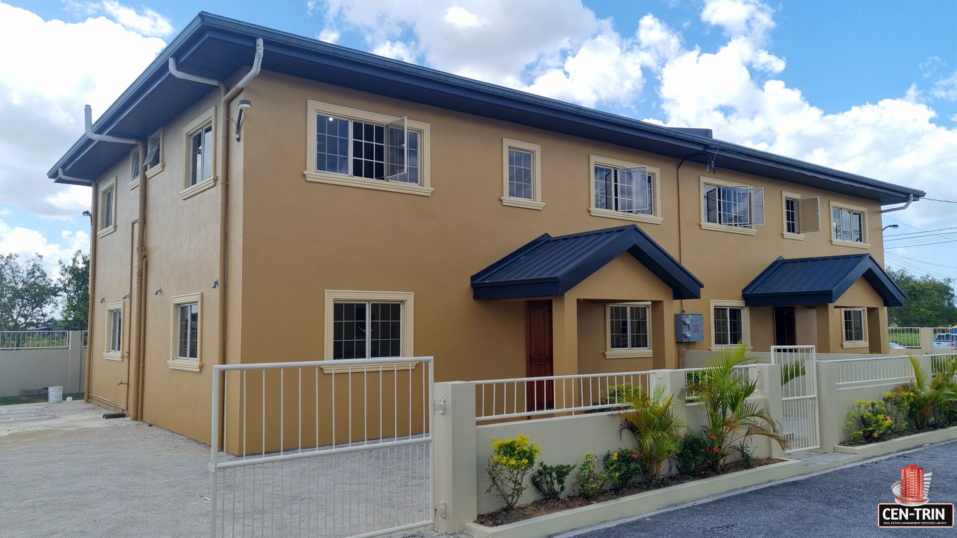 Townhouse for sale with fence and multiple windows.
