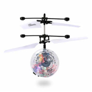 A clear, induction flying toy with colorful confetti inside, levitating and spinning in mid-air.