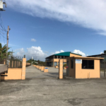 commercial building for sale with exterior view of a commercial building in Calcutta Freeport, Trinidad, showcasing ample parking space.