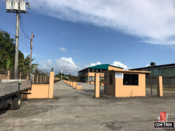 Commercial Building for Sale Freeport | Invest Opportunity 18 commercial building for sale with exterior view of a commercial building in Calcutta Freeport, Trinidad, showcasing ample parking space.