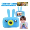 Young boy holding a blue Rabbit digital camera, perfect for kids in Trinidad and Tobago.