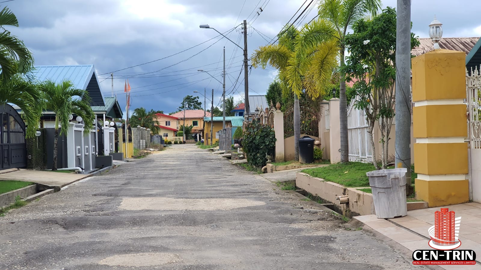 A view down a residential street in Krystal Gardens, Freeport, showing existing homes, paved road, and utility poles, providing context for the land for sale in Trinidad within this established community.