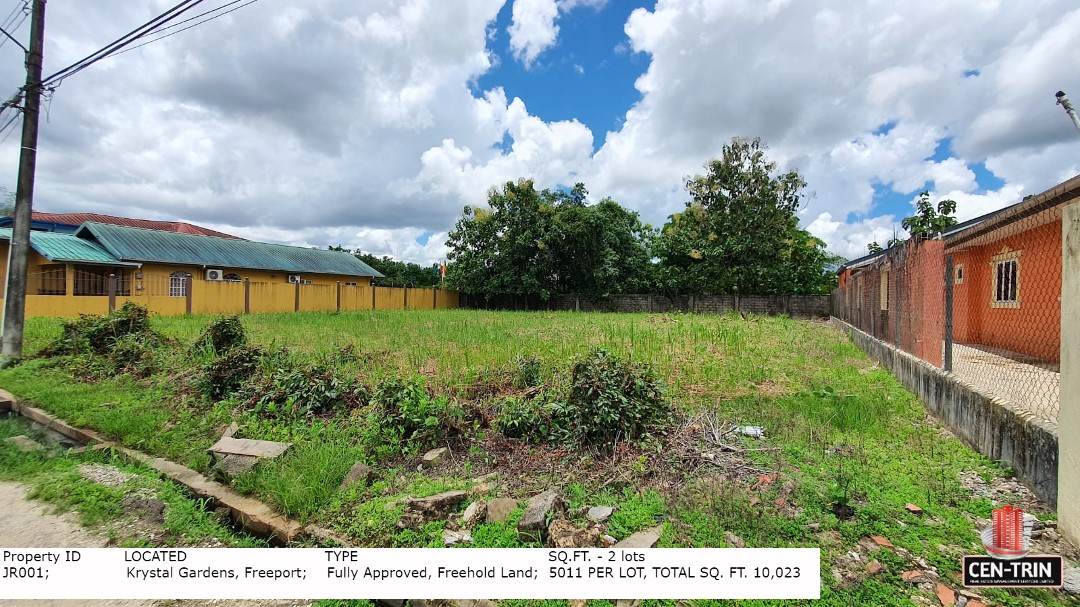 A clear, grassy, and level plot of land for sale in Trinidad, located in Krystal Gardens, Freeport, suitable for building a home. The image shows the dimensions of the lot (5011 sq. ft), and the surrounding partially built up area.
