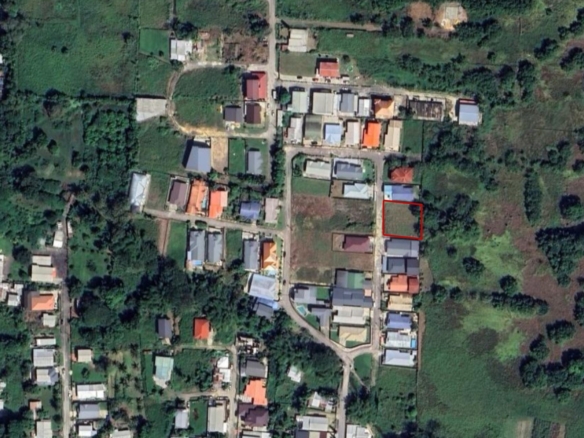 A satellite map view of the Krystal Gardens development in Freeport, Trinidad, showing Lot 10 and Lot 11 as prime approved land for sale in Trinidad, with markers for 5,000 sq ft per lot, gated development, fully approved status, and location in Freeport.
