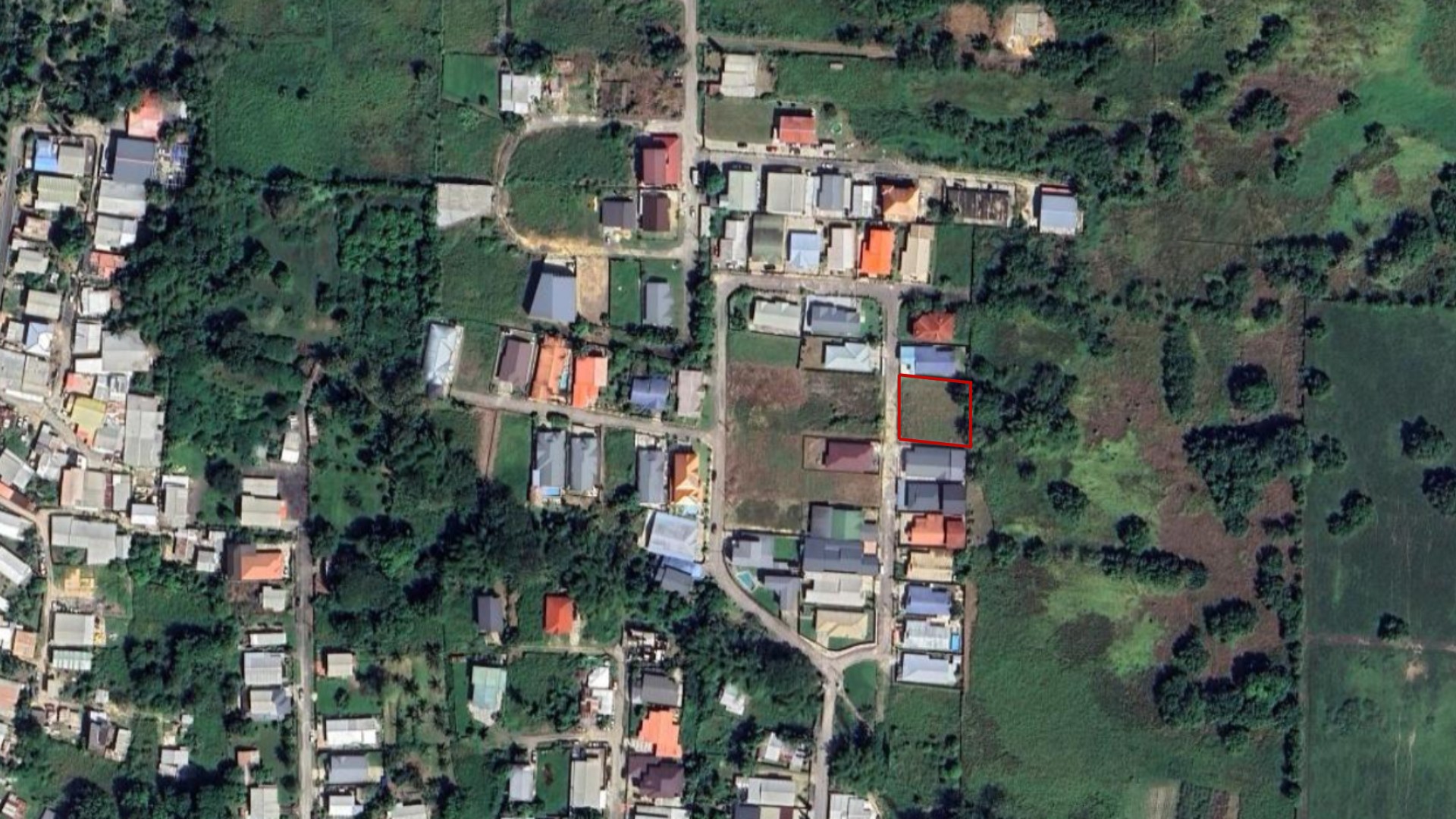 A satellite map view of the Krystal Gardens development in Freeport, Trinidad, showing Lot 10 and Lot 11 as prime approved land for sale in Trinidad, with markers for 5,000 sq ft per lot, gated development, fully approved status, and location in Freeport.