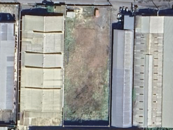 Aerial view of a large, rectangular commercial land for rent parcel in Aranguez, Patraj Trace, marked with dimensions and surrounded by commercial buildings, ideal for rent