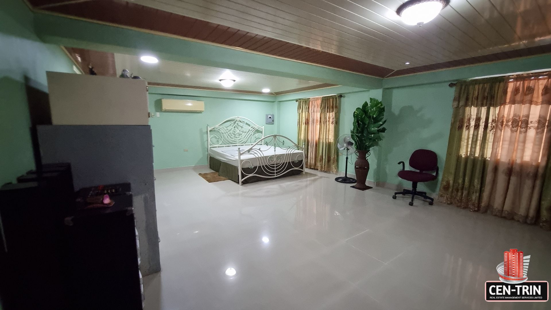Large, fully furnished bedroom with air conditioning and ample space in this luxury home for sale in Cunupia