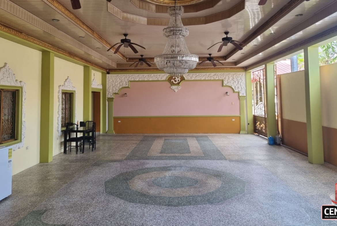 Exceptionally large garage space at this luxury home for sale in Cunupia with tiled floor and decorative ceiling.