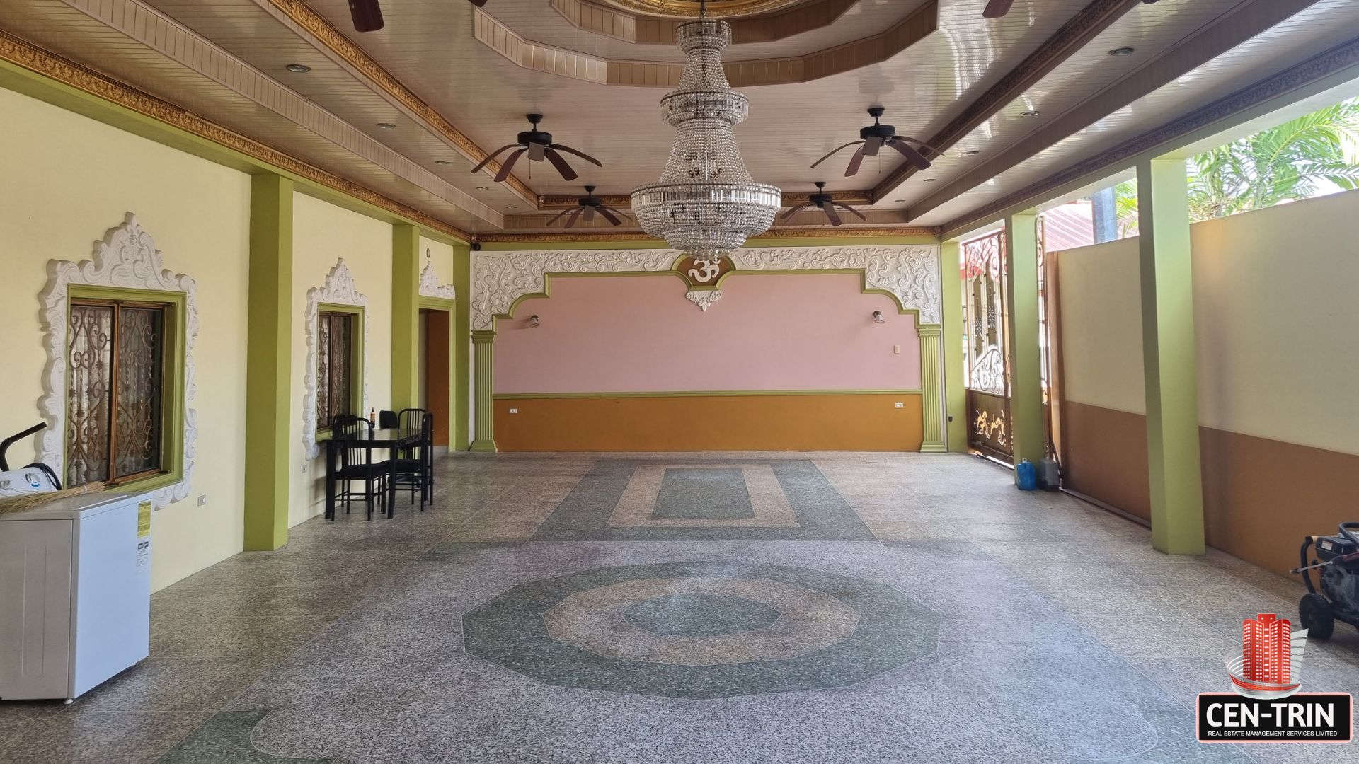 Exceptionally large garage space at this luxury home for sale in Cunupia with tiled floor and decorative ceiling.