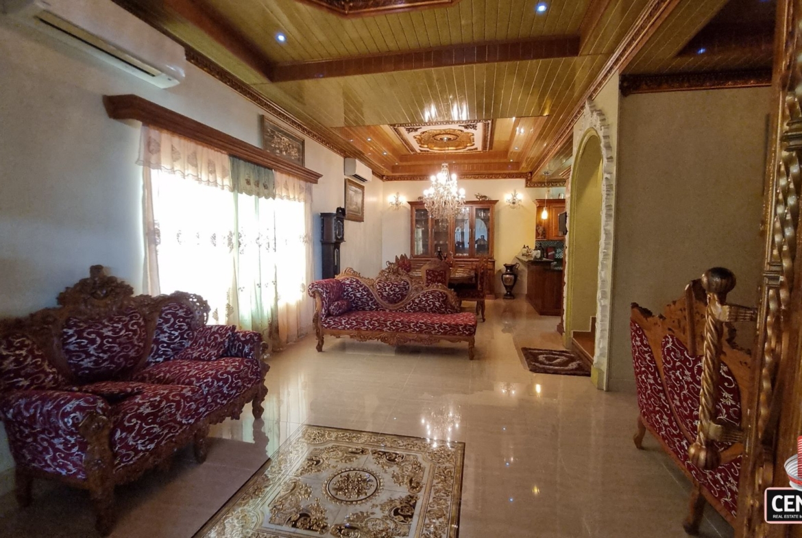Elegantly furnished living room with ornate furniture and decorative ceilings in this luxury home for sale in Cunupia