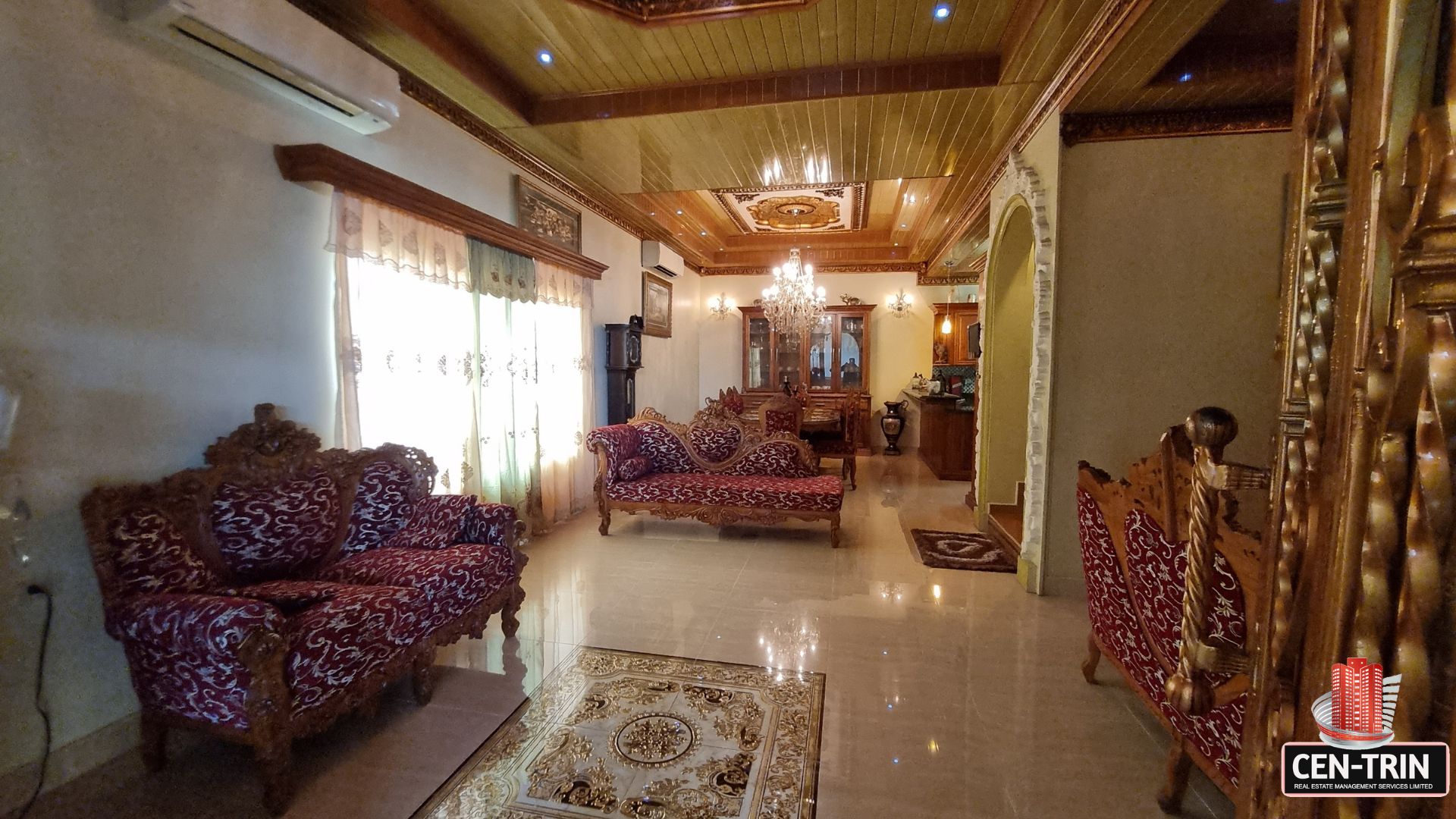 Elegantly furnished living room with ornate furniture and decorative ceilings in this luxury home for sale in Cunupia