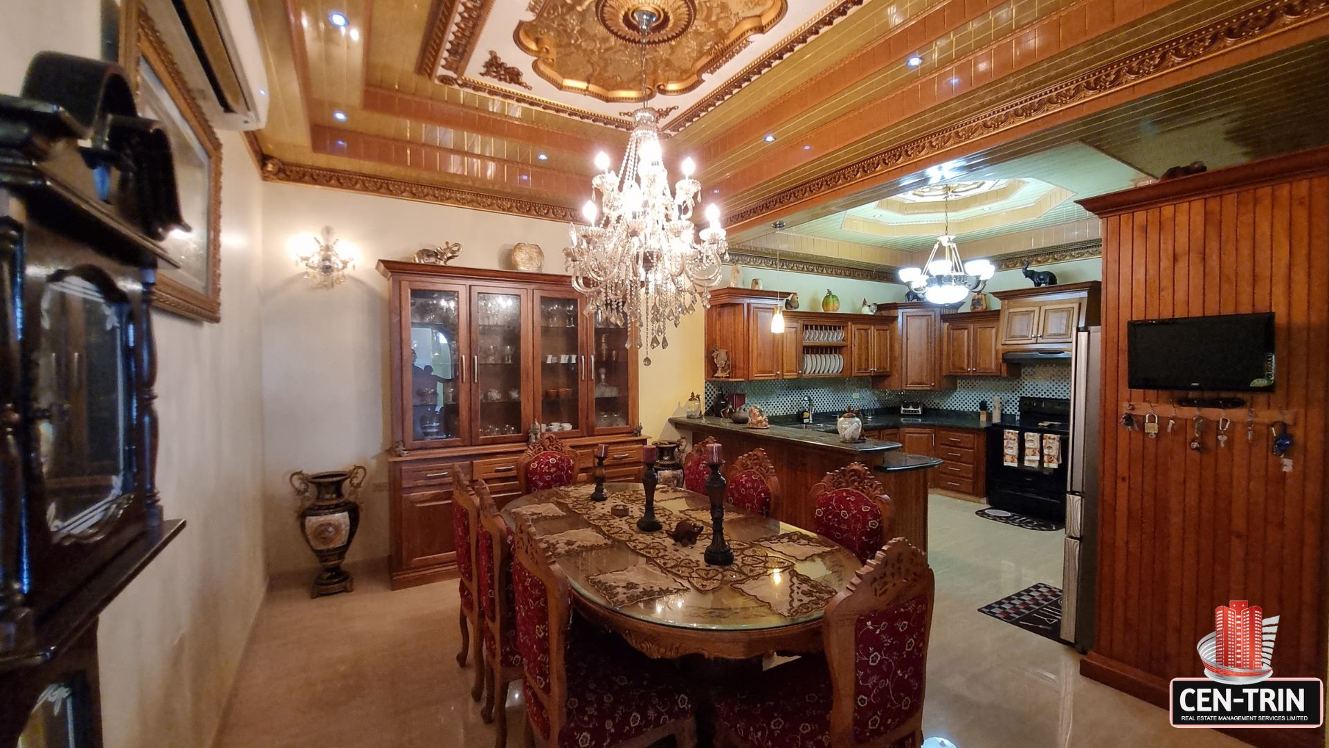 Elegant formal dining room open to a modern internal kitchen in this luxury home for sale in Cunupia