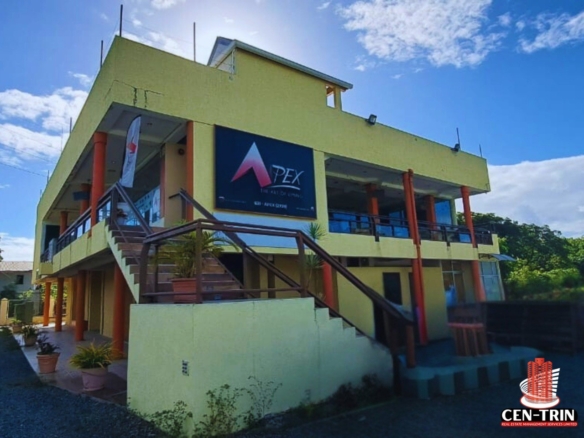 Tobago Property For Sale 12 Front exterior view of a prominent three-story commercial Tobago property for sale on Store Bay Local Road, featuring modern architecture and ample parking.