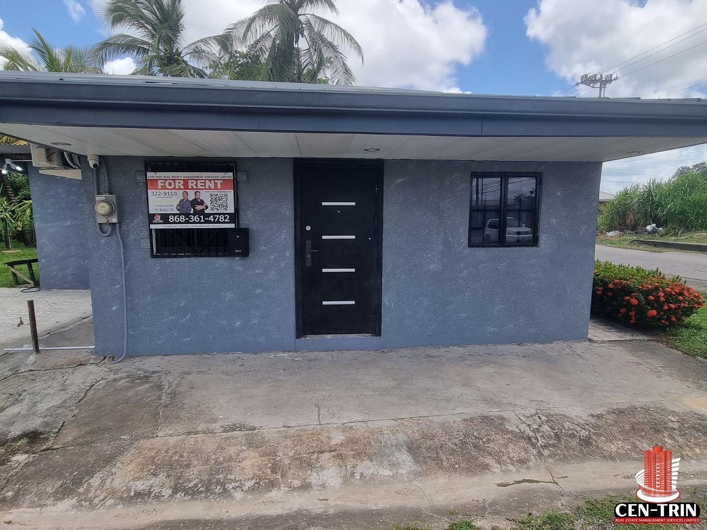 Small gray commercial rental building with a "For Rent" sign on Chin Chin Road.