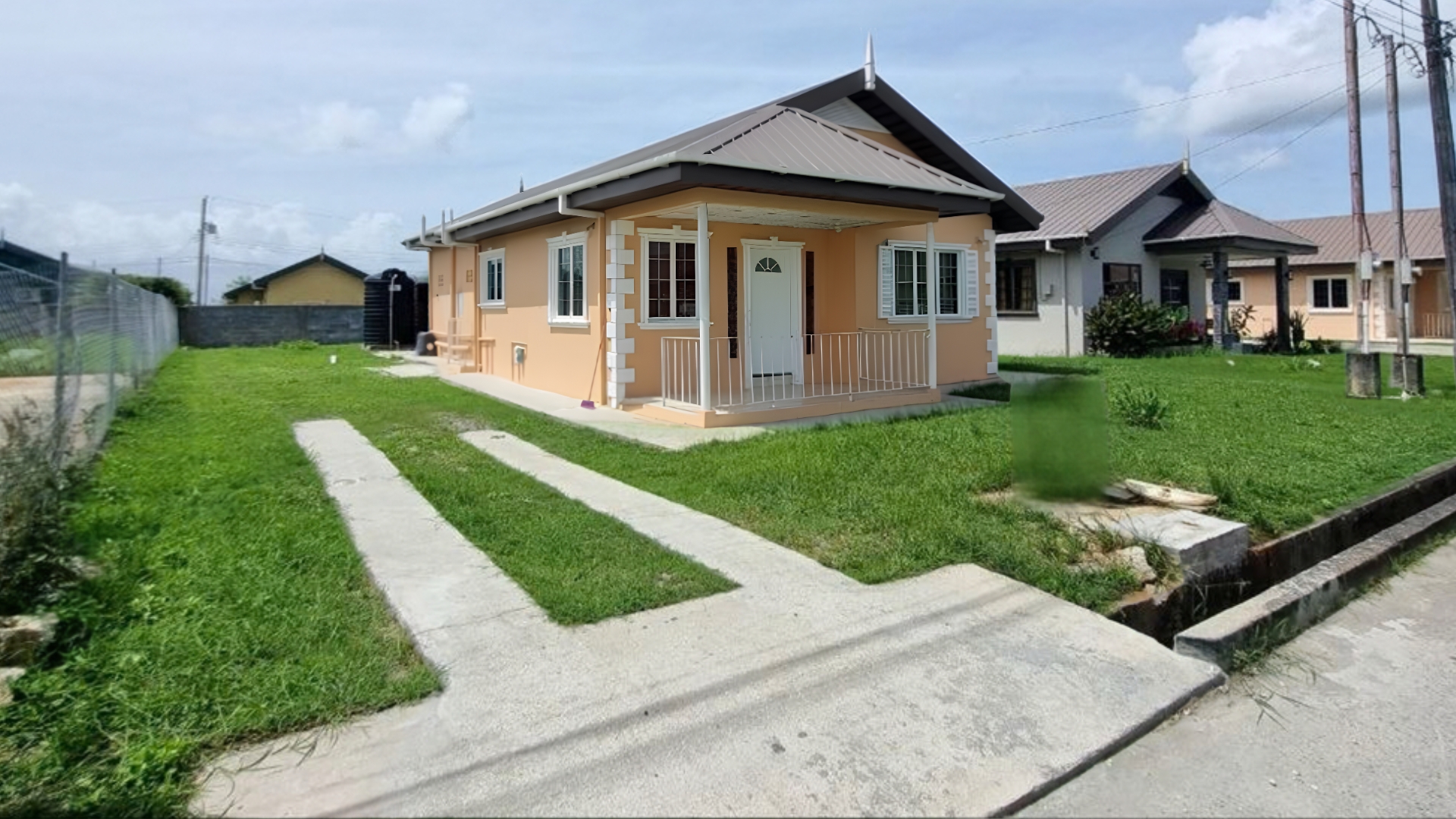 House for Rent | Eden Gardens, Freeport Street View & Lawn Front lawn driveway and neighborhood street view of house for rent in Eden Gardens Freeport